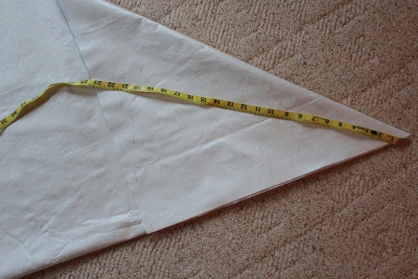 Measure the child from shoulder to below the her waist; Cut a circle from the vinyl tablecloth the same length