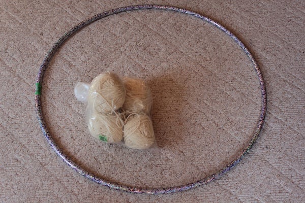 Tie 20 pieces of yarn from one side of the hoop to the other; cut off excess yarn.