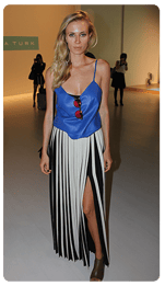 long knife-pleat skirt with a leg revealing slit and leather tank top